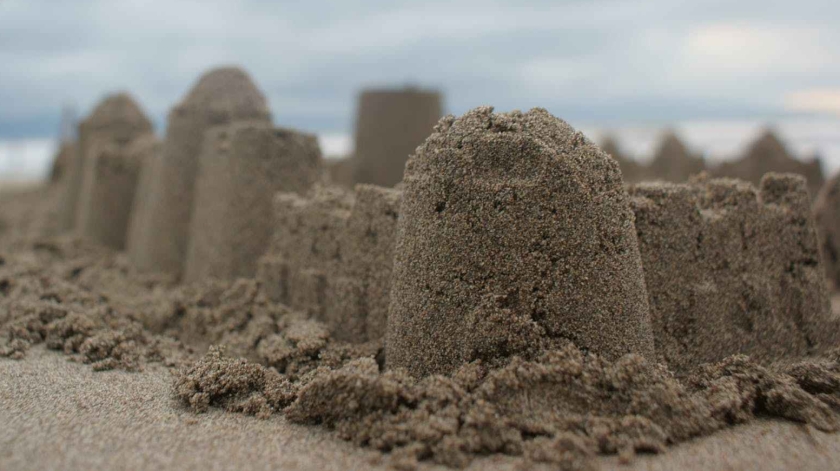 person standing near sand castle